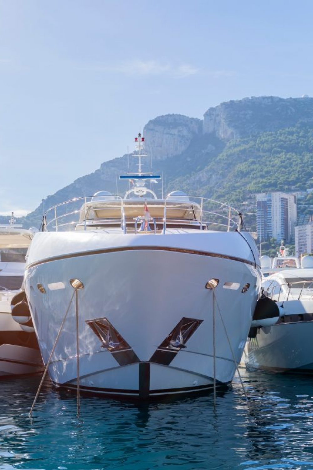 Three,Yachts,Moored,In,Monaco,Harbour,With,Monaco,Landscape,On